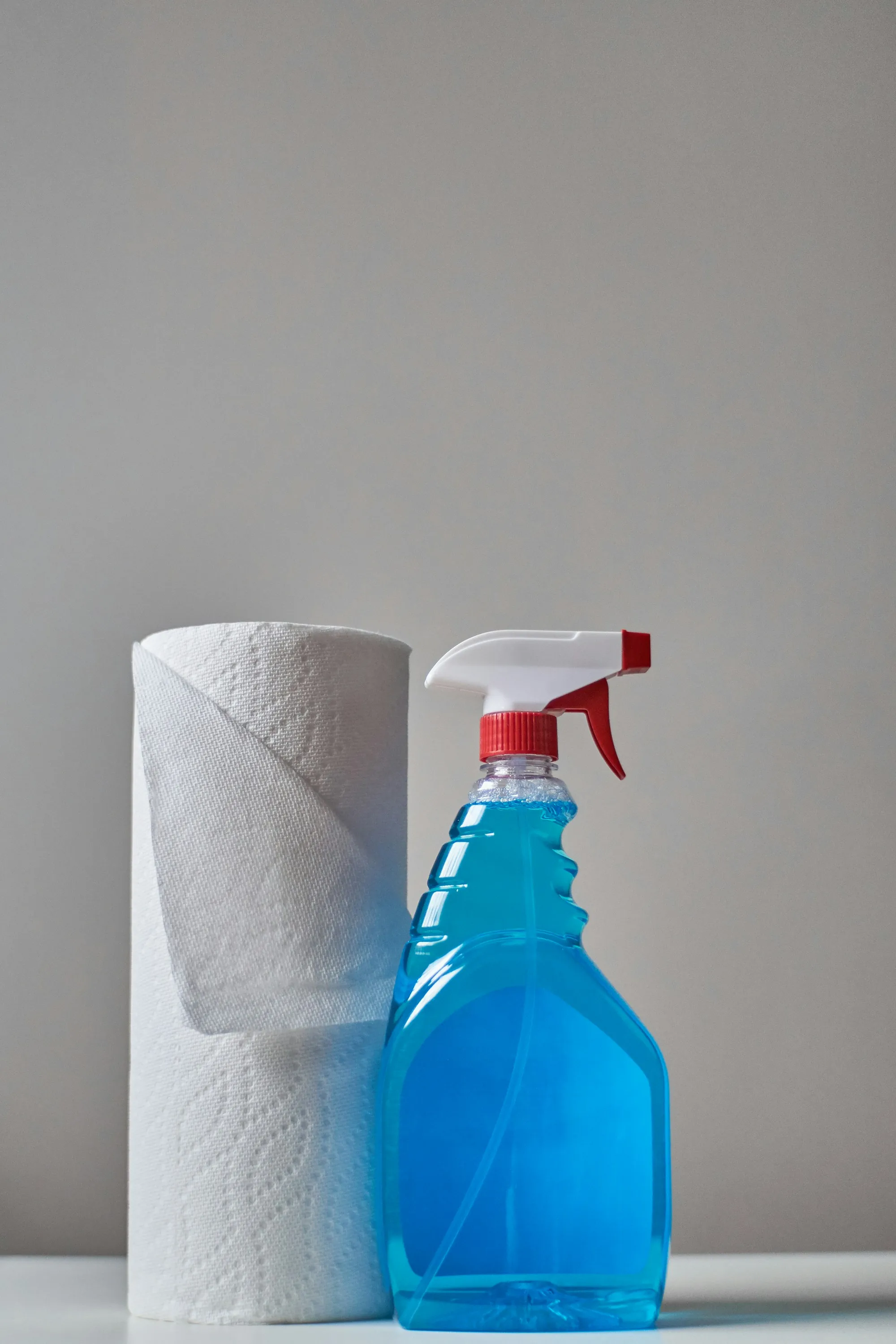 Paper towel roll and a blue spray bottle